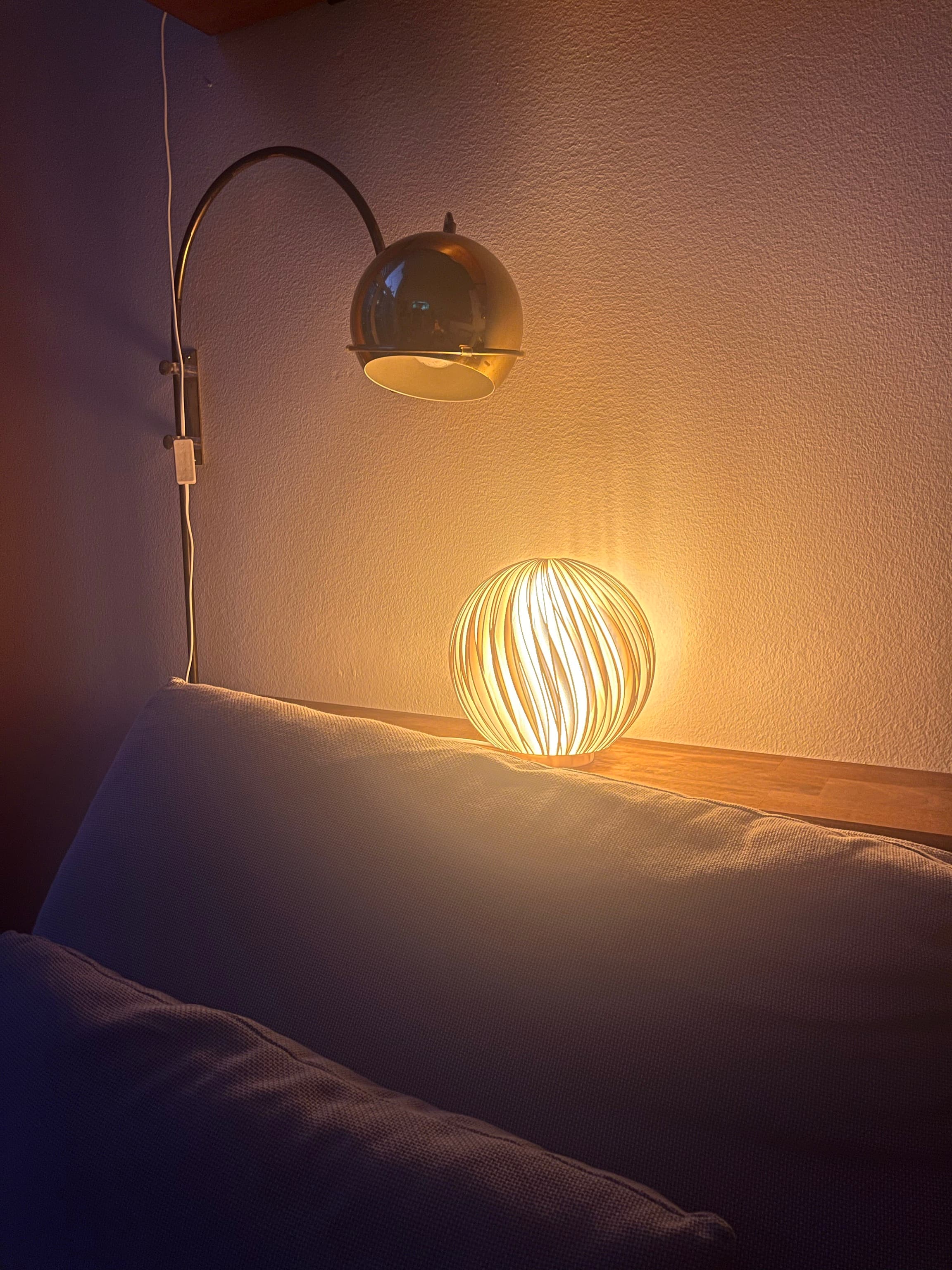 Lamella Lamp glowing on a table